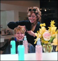 picture of a woman cutting another woman's hair